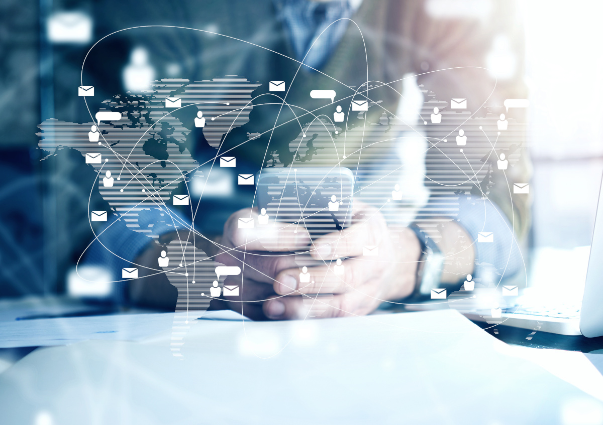 Man using phone with world communication icons digitally floating around