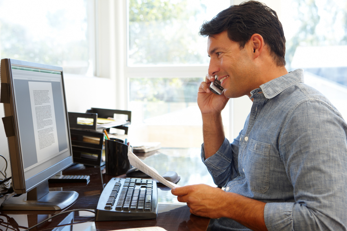 A man working remotely while talking on a phone