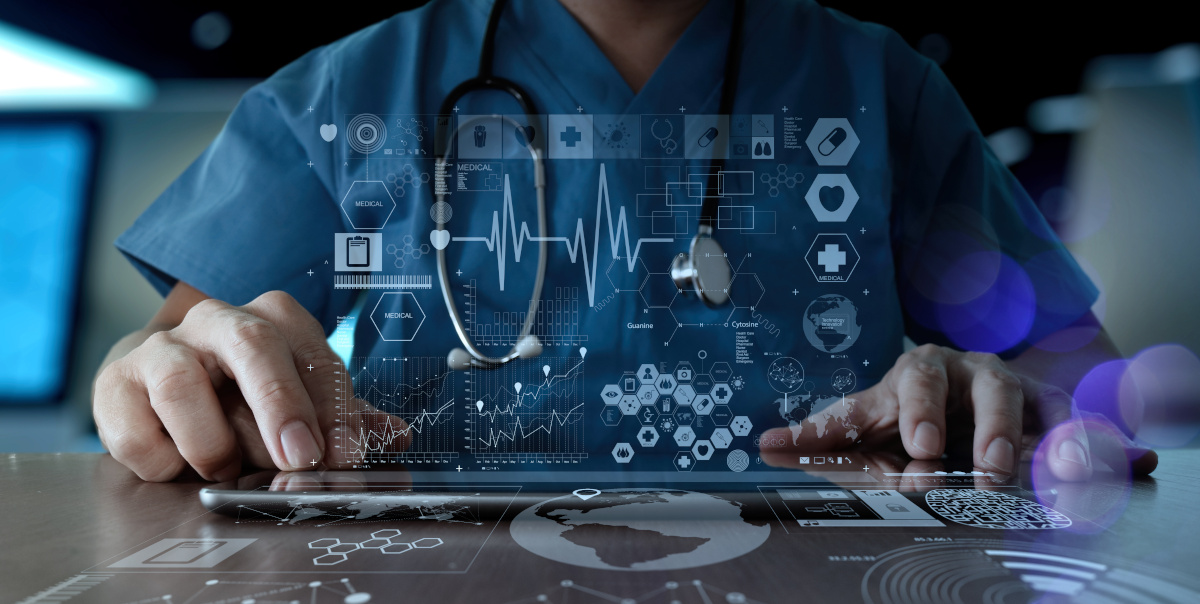 Man in scrubs using a tablet with a futuristic display