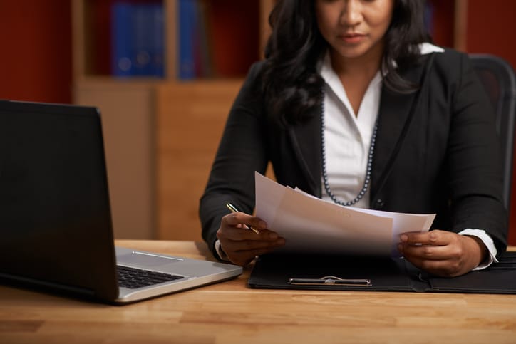 Cropped image of business woman reading contract in the office